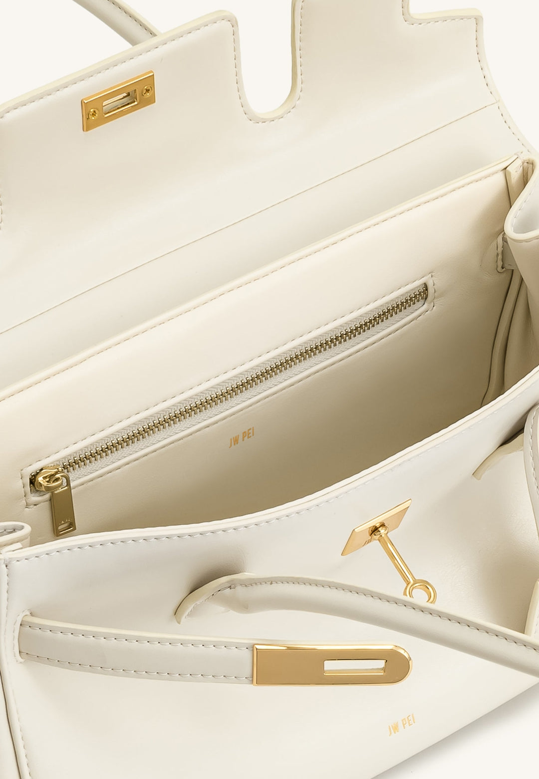 Intérieur d'un sac bandoulière JW PEI Yara blanc avec fermeture éclair dorée et logo de la marque