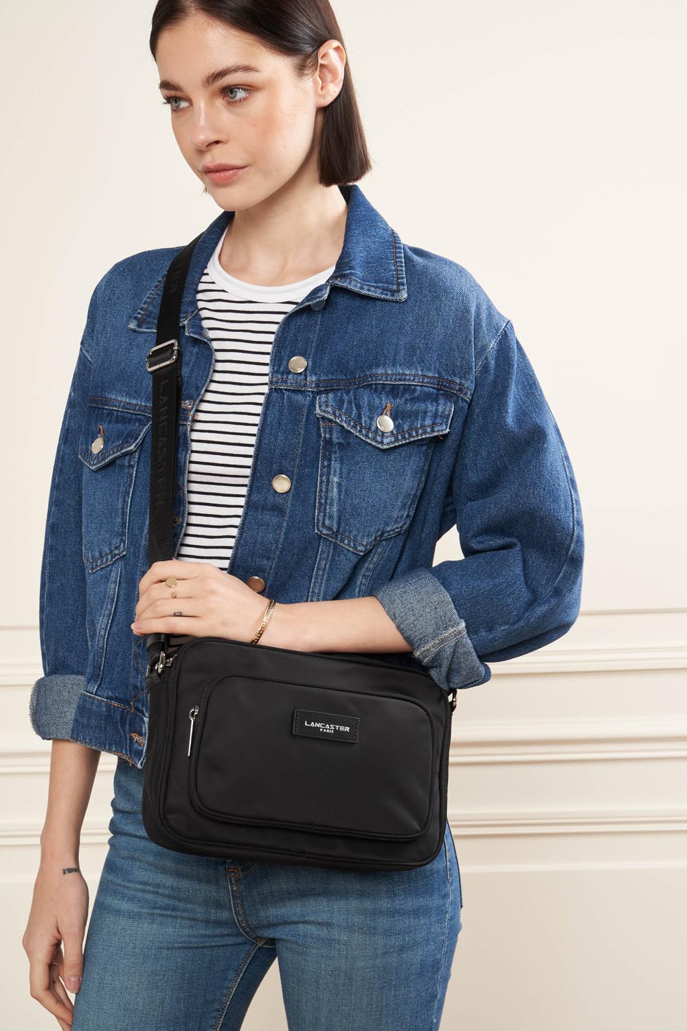 Lancaster Zipped Crossbody Bag Basic Vita Atoll Blue – The black Trotteur Basic Vita is worn crossbody with a denim jacket and a striped top.