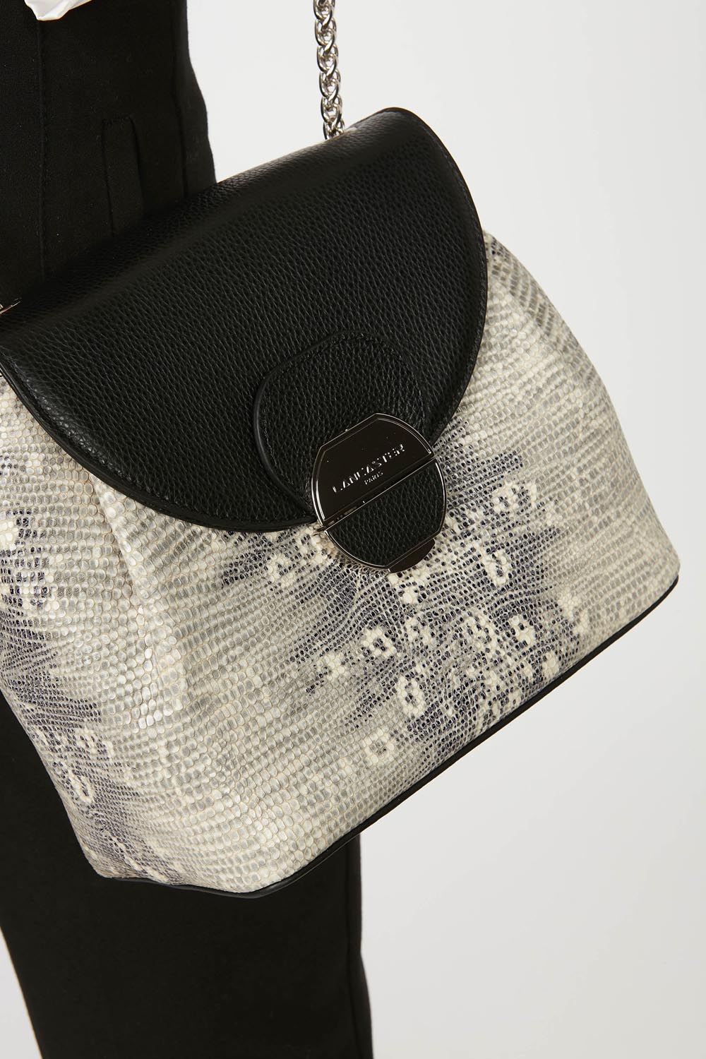 Lancaster Borsa a tracolla con patta e chiusura Pia Camel – A spalla, la borsa trotteur Pia nera e beige si abbina a un look nero.